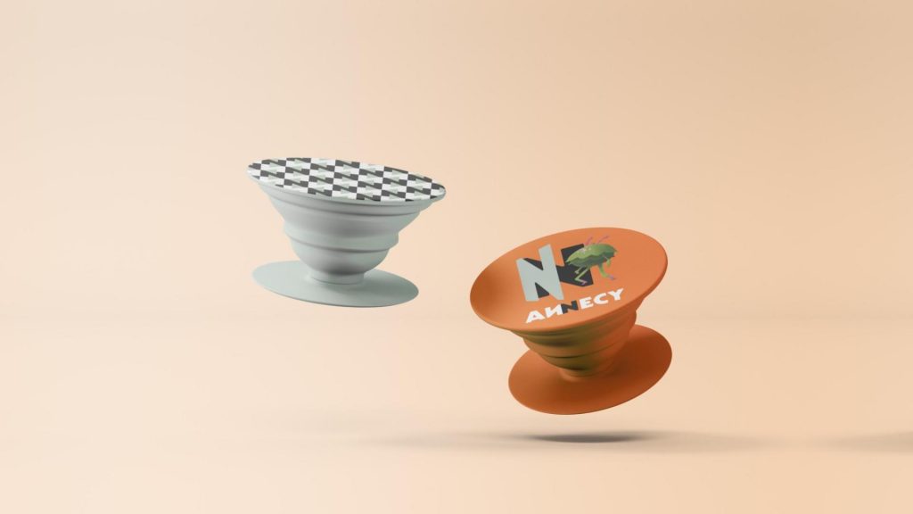 Orange and sage green pop sockets with ANNECY's logo and character